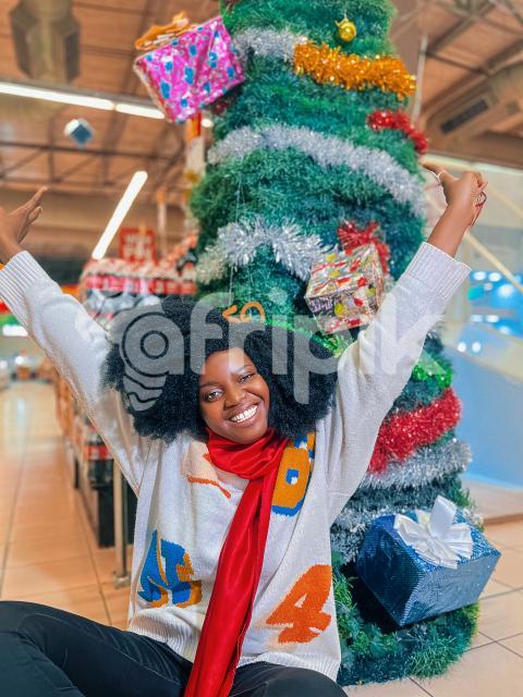Happy girl in front of a christmas tree