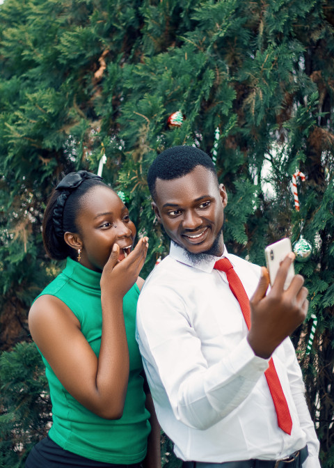 Girl and boy staring at a phone 1