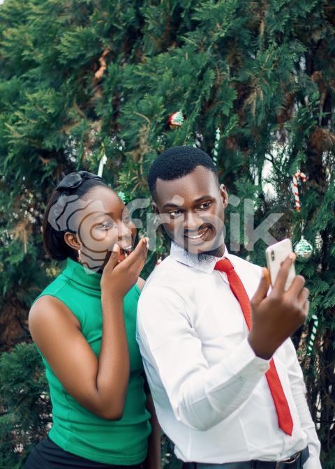 Girl and boy staring at a phone 1