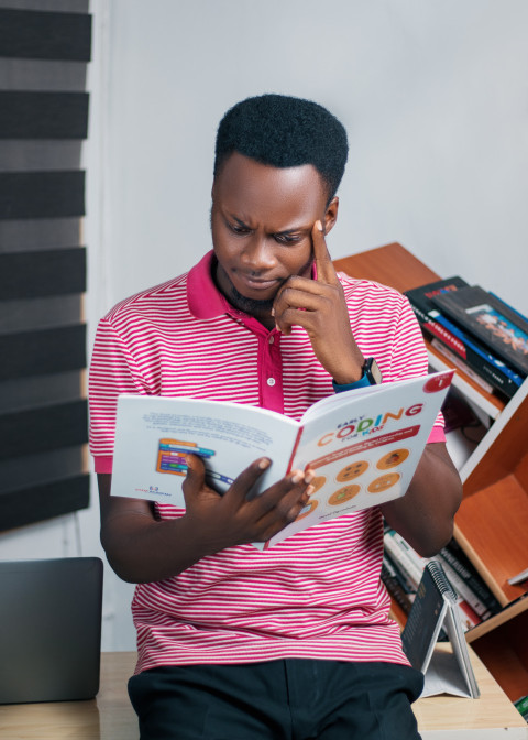 Teacher reading coding textbook