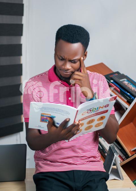 Teacher reading coding textbook