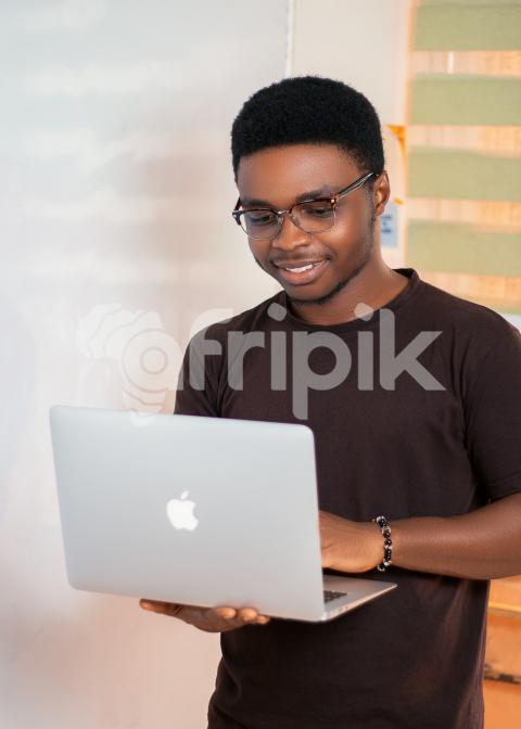 Boy pressing a laptop