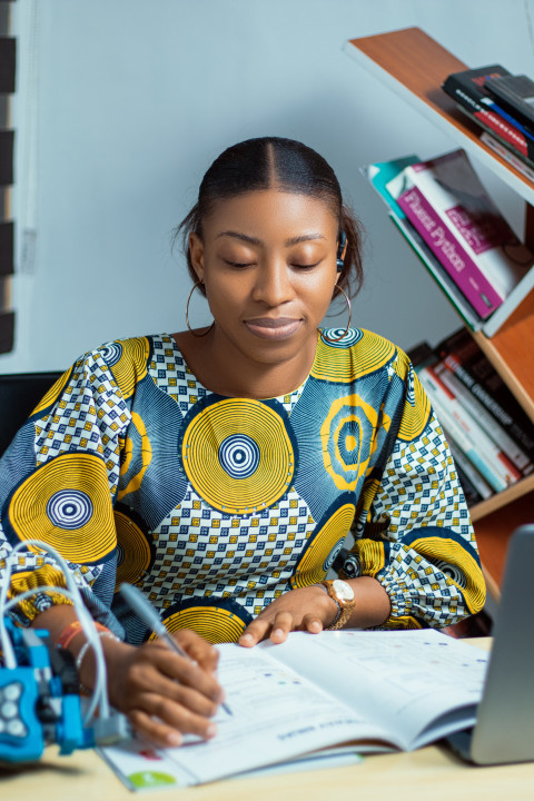 Girl writing in a texbook