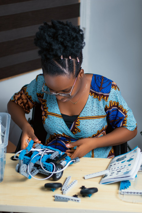 Girl working with her robotics kit