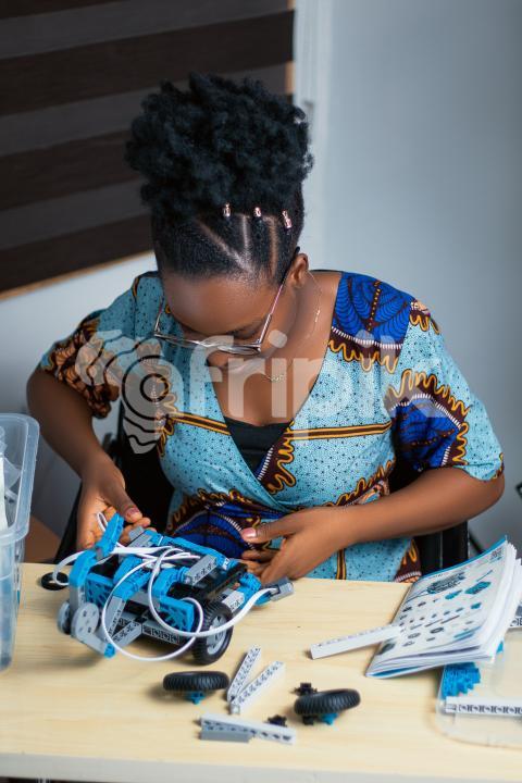 Girl working with her robotics kit