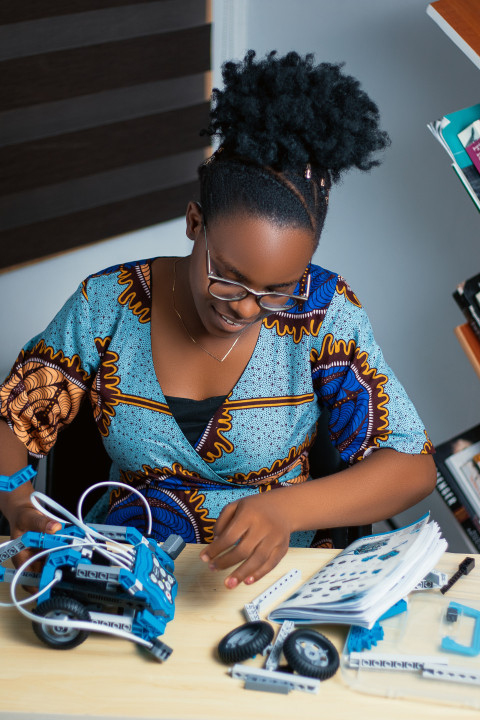 Girl working with her robotics kit 2