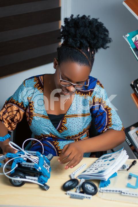 Girl working with her robotics kit 2