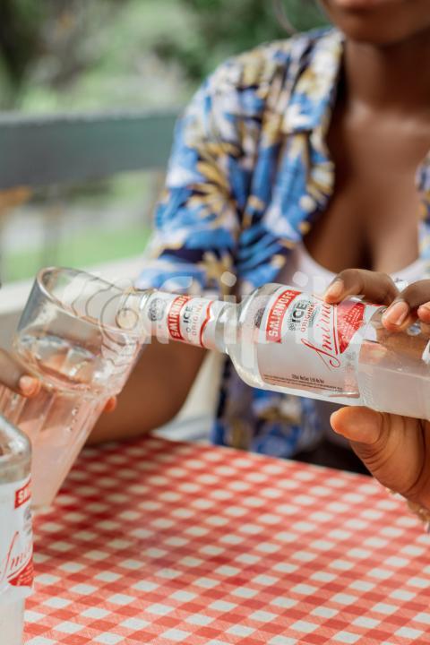 Girl pouring drink into a glass cup 1