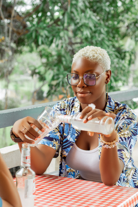 Girl   pouring drink into a glass cup 2