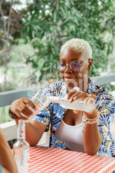 Girl   pouring drink into a glass cup 2