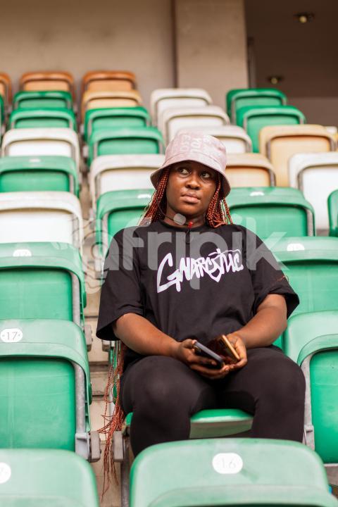Girl sitting in stadium