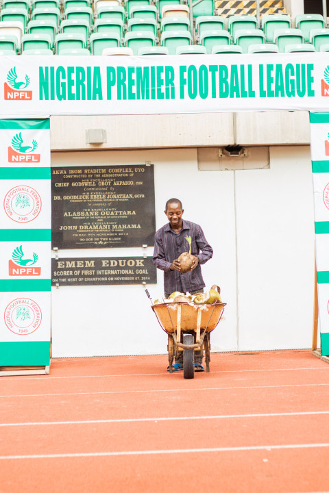 Man with coconut in wheelbarrow