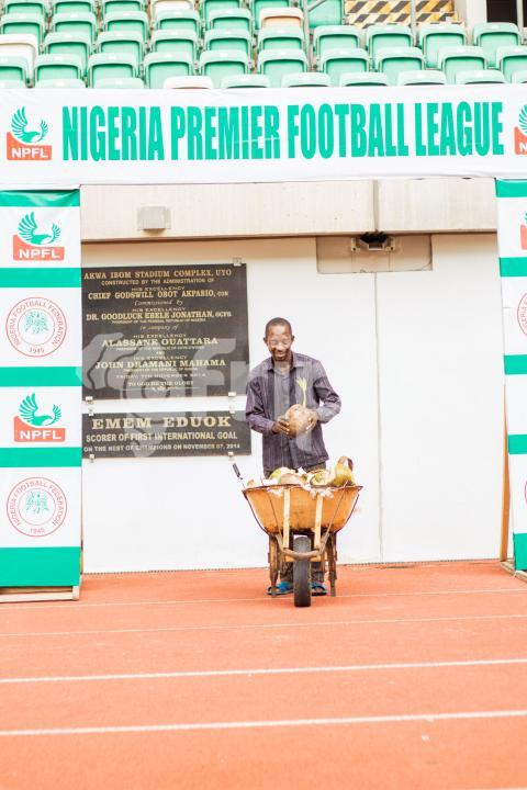 Man with coconut in wheelbarrow