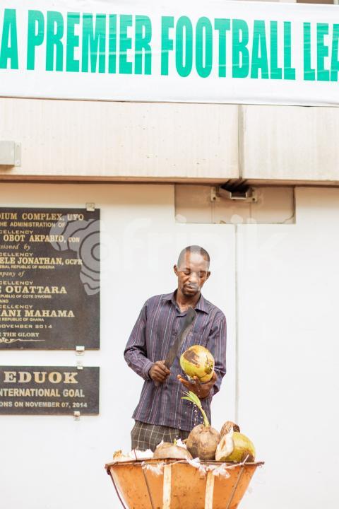 Man cutting coconut