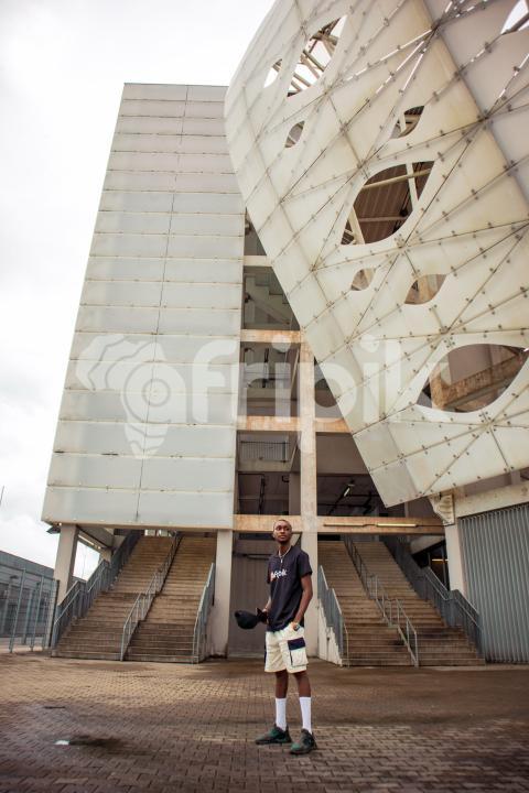 Boy standing in front of stadium 1