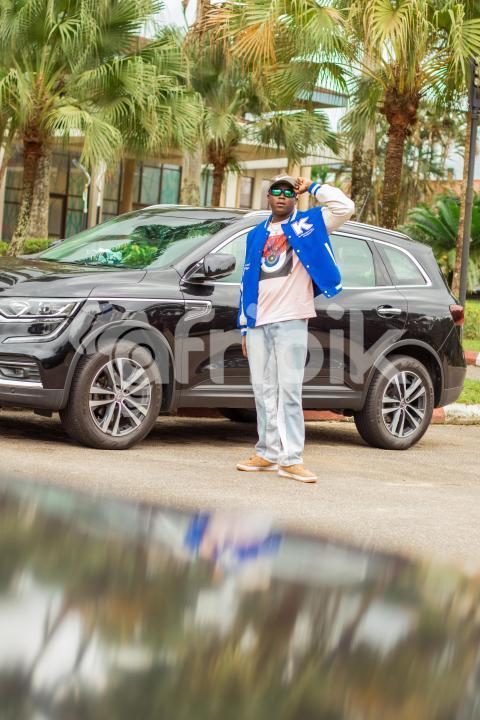 A Boy standing in front of car 1