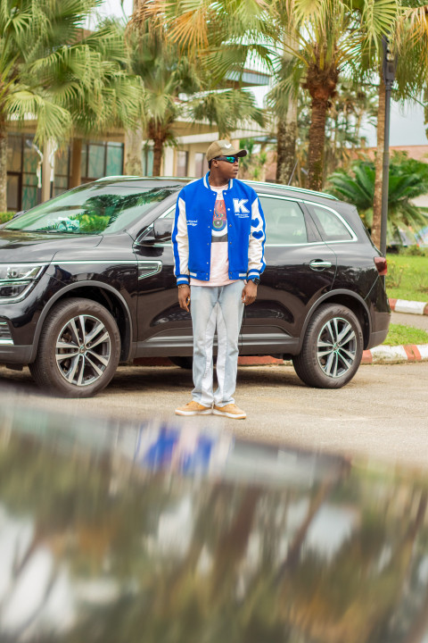 A boy in front of car 2