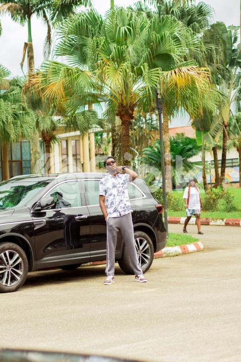 Boy standing in front of car 4