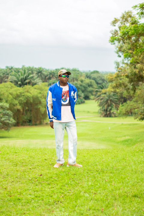 Boy standing in a beautiful grass lawn