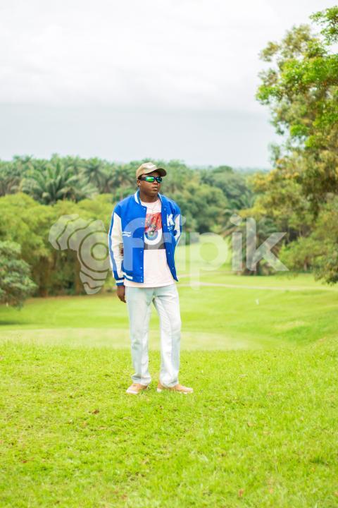 Boy standing in a beautiful grass lawn