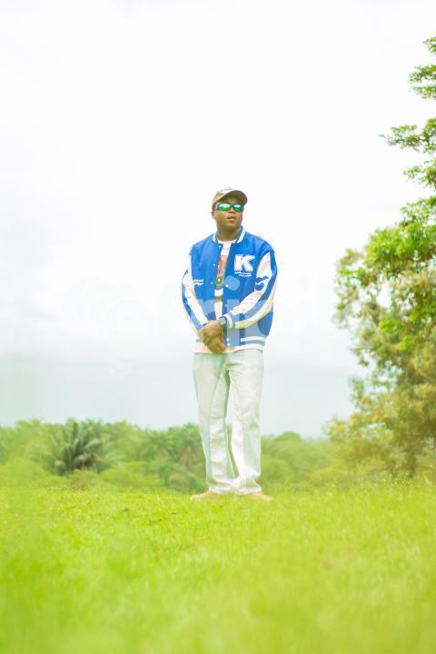 Boy standing in a beautiful grass lawn 1