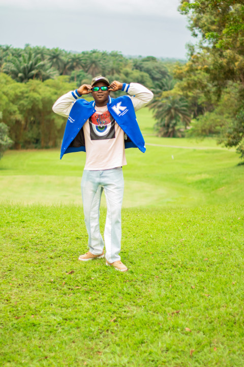 Boy standing in a beautiful grass lawn 2