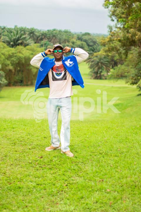 Boy standing in a beautiful grass lawn 2