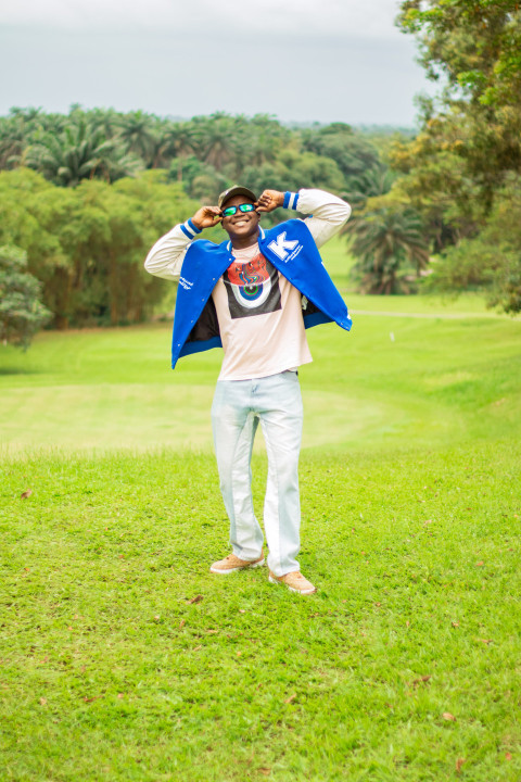 Boy standing in a beautiful grass lawn 3