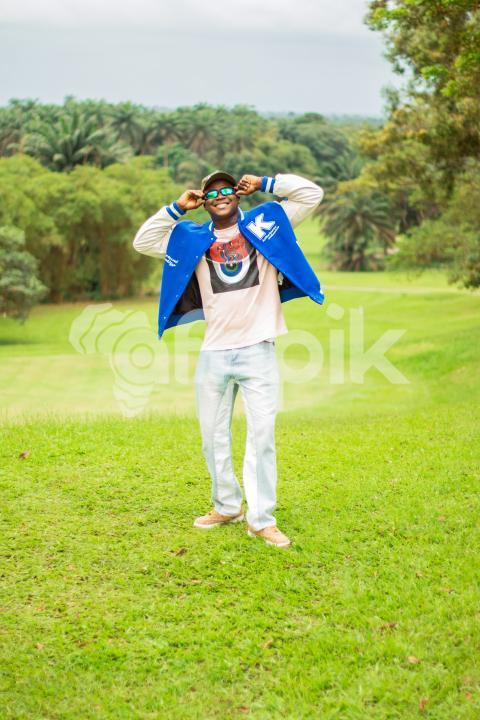 Boy standing in a beautiful grass lawn 3