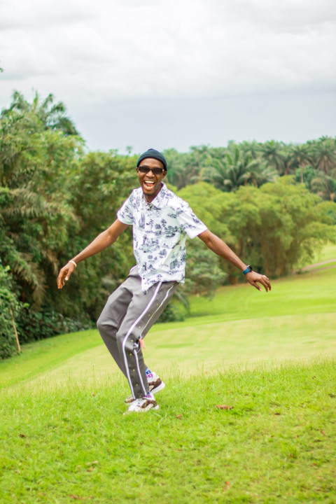 A happy boy in a beautiful grass lawn 1