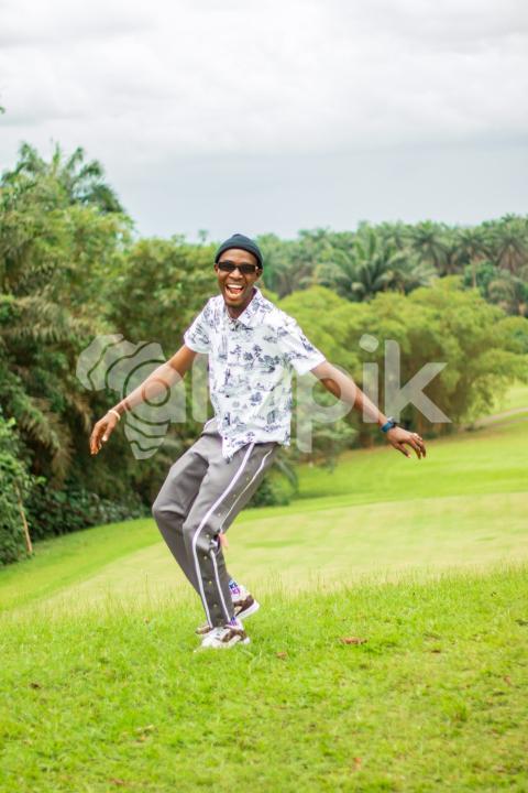 A happy boy in a beautiful grass lawn 1