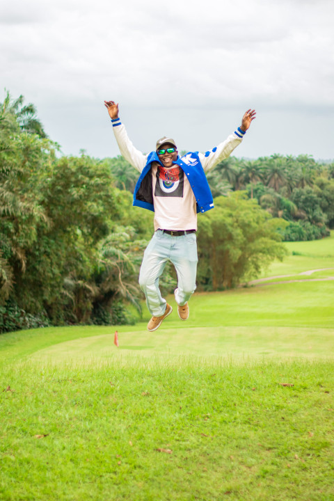 A boy jumping on a beautiful grass lawn 1