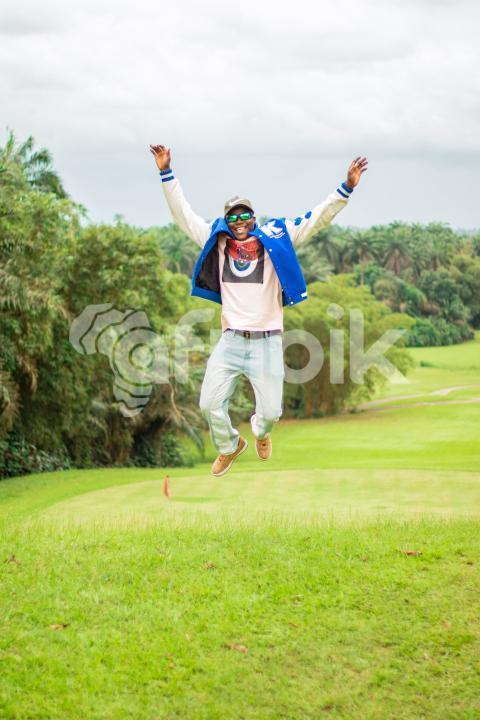 A boy jumping on a beautiful grass lawn 1