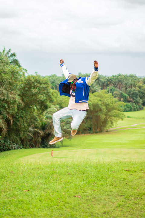 A jumping boy on a beautiful grass lawn 2