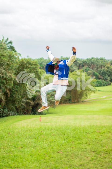 A jumping boy on a beautiful grass lawn 2