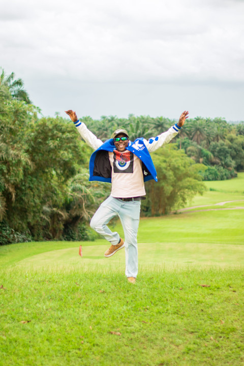 A boy jumping on a beautiful grass lawn 3