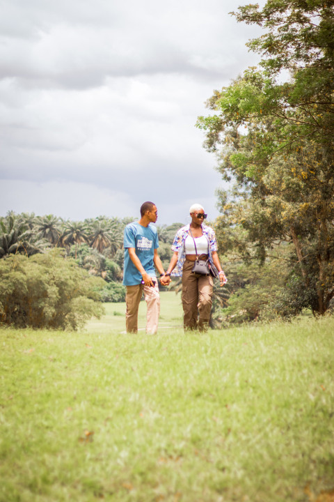 Boy and girl walking across a grass line