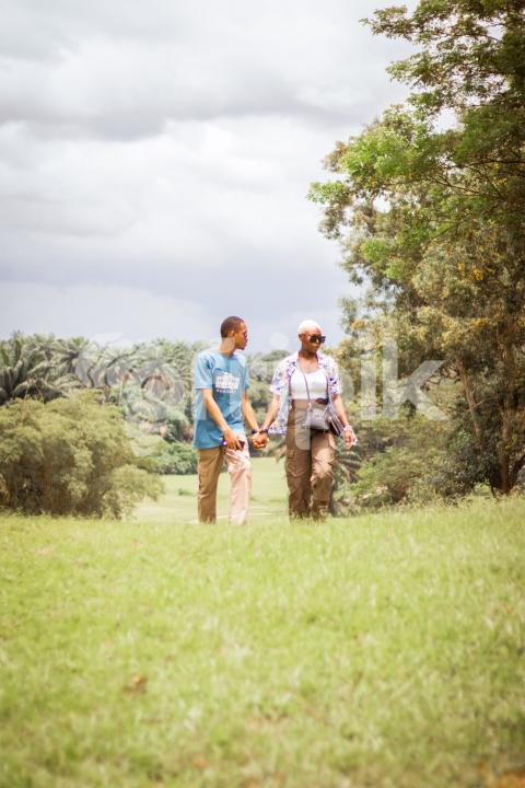Boy and girl walking across a grass line