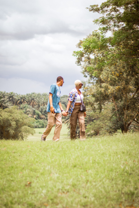 Boy and girl walking across a grass line 1