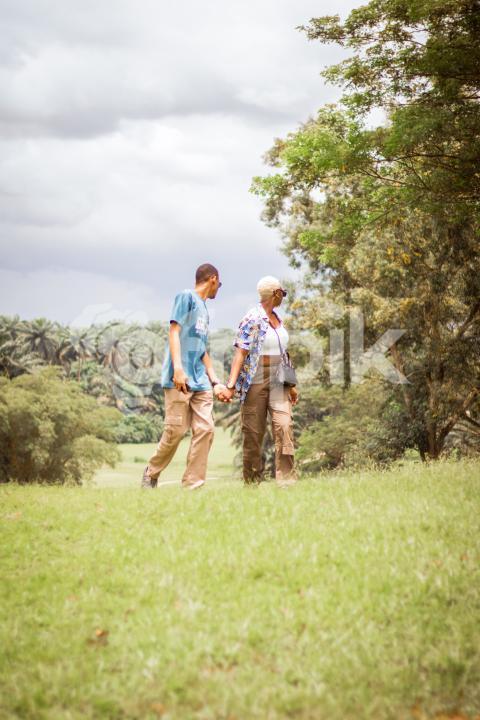 Boy and girl walking across a grass line 1