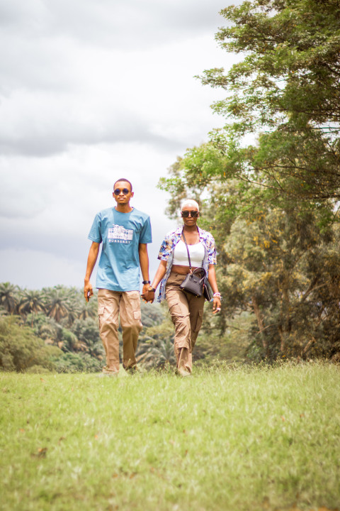 Boy and girl walking across a grass line 2