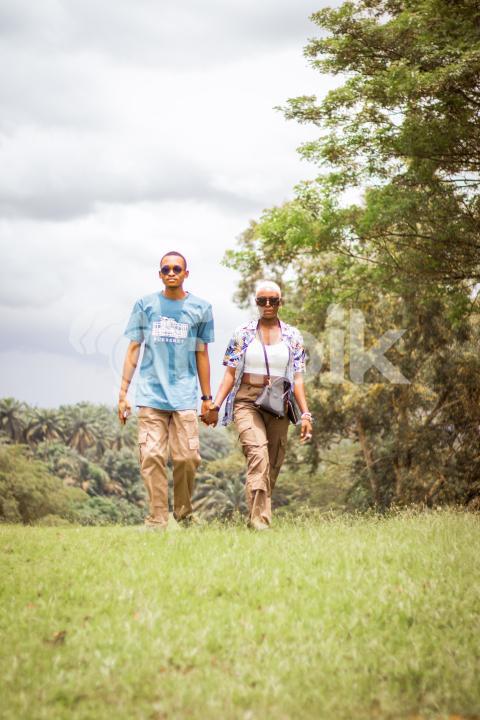 Boy and girl walking across a grass line 2