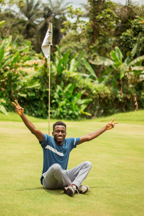 A happy boy sitting on grass 1