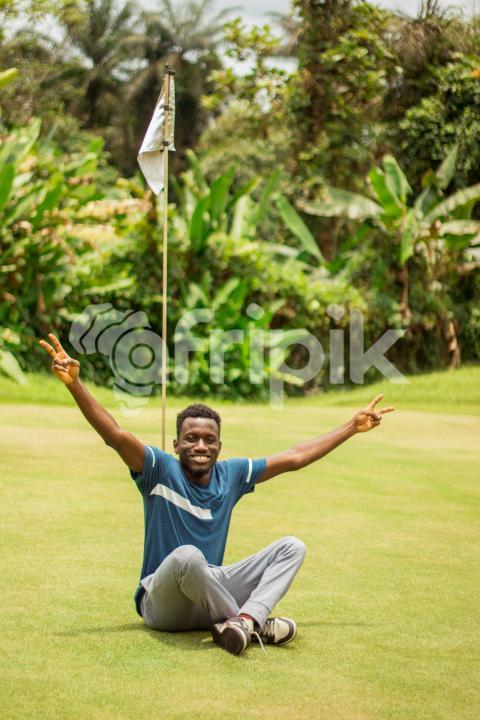 A happy boy sitting on grass 1