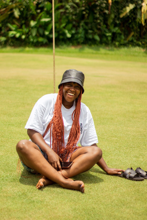 Laughing girl sitting on grass