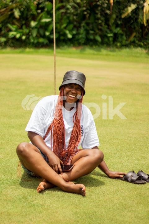 Laughing girl sitting on grass