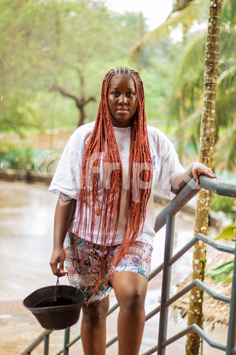 Girl standing by staircase railing