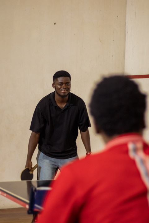 Cheerful boy playing table tennis