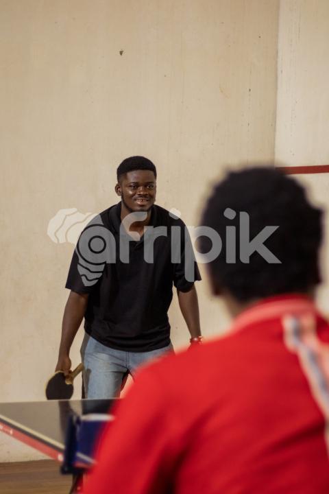 Cheerful boy playing table tennis