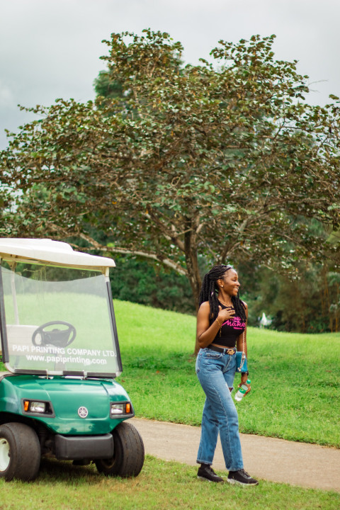 Girl in front of a Golf cart